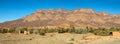 Moroccan clay houses near mountains and palms Royalty Free Stock Photo