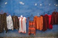 Moroccan clothes hang on a wall in Chefchaouen