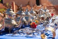 Moroccan craft souvenirs on street market. Teapots, jewelry, tagines, trinkets