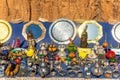 Moroccan craft souvenirs on street market. Teapots, jewelry, tagines, trinkets