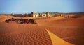 A moroccan desert scenery with an arabian camp of colourful tent