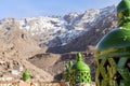 Moroccan green lantern on the top of the fence with Toubkal mountain range in Morocco