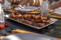 Moroccan kefta on a plate with a dinner scene in the background