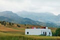 Moroccan landscape with mountains, field and lonely building