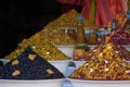 Moroccan local market with a stall of different types of olives and bottles of olive oil