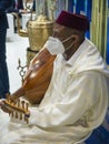 Moroccan musician playing an Arabian lute (oud) at the Morocco stand in FITUR 2022