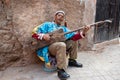 Moroccan musician playing guitar from Morocco, gumbri, guembri or hajhouj, Marrkech