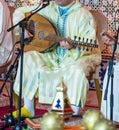 Moroccan musician wearing a Moroccan djellaba plays the Oud