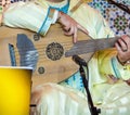 Moroccan musician wearing a Moroccan djellaba plays the Oud