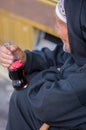 Moroccan senior holding a bottle of Coca-Cola