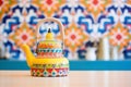 moroccan themed teapot placed on colourful ceramic tiles