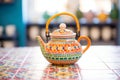 moroccan themed teapot placed on colourful ceramic tiles