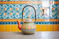 moroccan themed teapot placed on colourful ceramic tiles