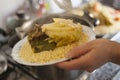 Moroccan traditional couscous plate dishing up.