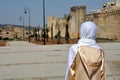 Moroccan woman in golden djellaba and white hijab