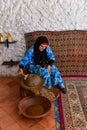 Moroccan woman grinding argan kernels, argan oil manufacture