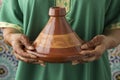 Moroccan woman with henna painted hands holding a tagine Royalty Free Stock Photo