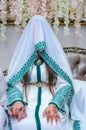 Moroccan woman with traditional henna painted hands.