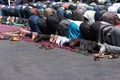 Moroccans praying in ramadan on carpet, posture mujut, copy-space. Salat