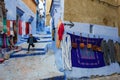 Morocco. Chefchaouen. A yung boy run in a typical decorated blue street of the medina