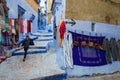 Morocco. Chefchaouen. A yung boy run in a typical decorated blue street of the medina