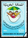 MOROCCO - CIRCA 1984: A stamp printed in Morocco shows Children and dove, circa 1984.