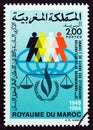 MOROCCO - CIRCA 1984: A stamp printed in Morocco shows human figures and scales, circa 1984.