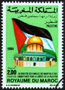 MOROCCO - CIRCA 1984: A stamp printed in Morocco shows Palestinian flag and Dome of the Rock, circa 1984.