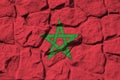 Morocco flag depicted in paint colors on old stone wall closeup. Textured banner on rock wall background Royalty Free Stock Photo