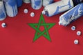Morocco flag and few used aerosol spray cans for graffiti painting. Street art culture concept