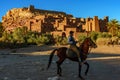 Morocco. Horses riders in front of ksar of Ait Ben haddou
