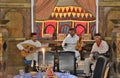 Morocco - March 2019. A folklore ensemble of musicians in national clothes performs traditional music and songs in a restaurant