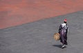 Morocco, Marrakesh, Moroccan man backwards with drum at the Place Jemaa-el-Fna square, copy-space