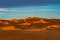 Morocco. Merzouga. Sand dunes of Sahara desert under a blue sky at dusk