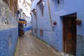 Blue house, old window and brick eaves in Morocco