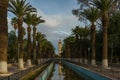Morocco. Taroudant. Irrigation canals (seguias), lined with palm trees, in the background the minaret of the mosque Royalty Free Stock Photo