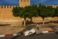 Morocco. Taroudant. A man pushing a cart in front of the city walls