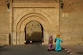 Morocco. Taroudant. Two women in a chador in front of the Bab Sedra gate of the city walls