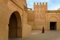 Morocco. Taroudant. A woman in a chador in front of the city walls