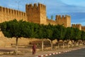 Morocco. Taroudant. A woman walking front of the city walls