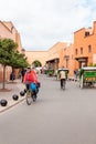 Moroccon man riding a bike near the Kasbah of Marrakesh, Morocco