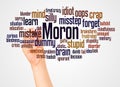 Moron word cloud and hand with marker concept Royalty Free Stock Photo