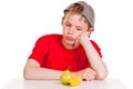 Morose young boy staring at a ripe banana and pear Royalty Free Stock Photo