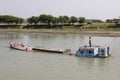 Morrelganj, Bangladesh, February 27 2017: Overloaded cargo ship is driving on a river in Bangladesh