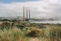 Sand dunes, native plants, and power plants on Morro Bay, California. Three 450-feet-high power plant visible from 10 miles away Royalty Free Stock Photo