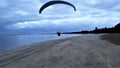 Morro de sao paulo beach.Paragliding flight practice with motor landing at sea shore