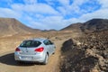 MORRO JABLE TO COFETE BEACH ROAD, FUERTEVENTURA - FEB 8, 2014: hire car on unpaved road to Cofete beach. This area is secluded Royalty Free Stock Photo