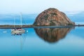 Morro Rock, Morro Bay California. Harbor with sailboat in foreground. Reflection on the water. Royalty Free Stock Photo