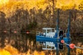 Fishing Boat in Lake Lure with fall season background. Royalty Free Stock Photo