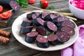Morsilla - blood sausage. Pieces of Spanish black pudding on a plate. Easter menu Royalty Free Stock Photo